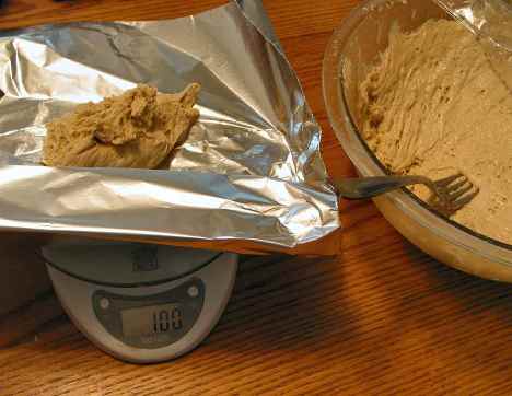 Weighing a sample of raw dough to figure carbs after baking