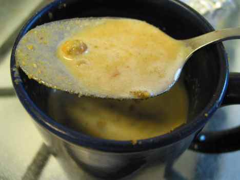 Ground toasted pistachios steeping in hot milk