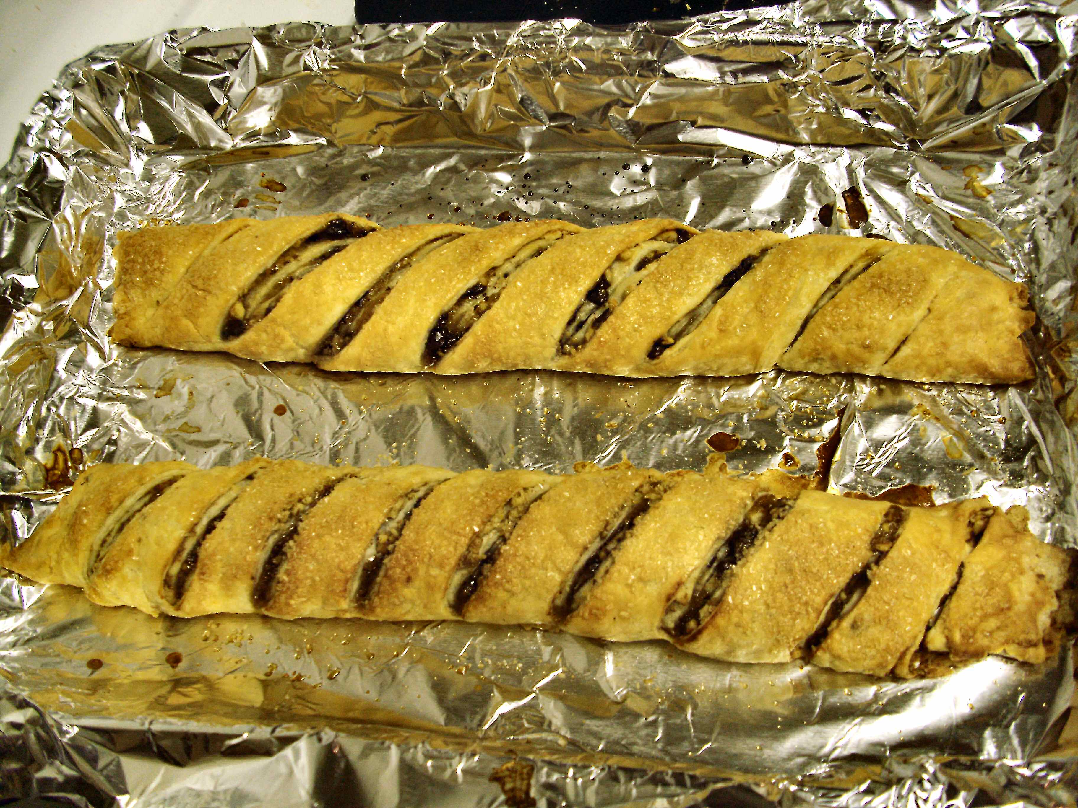 Rugelach rolls slashed, baked and ready to be cut apart