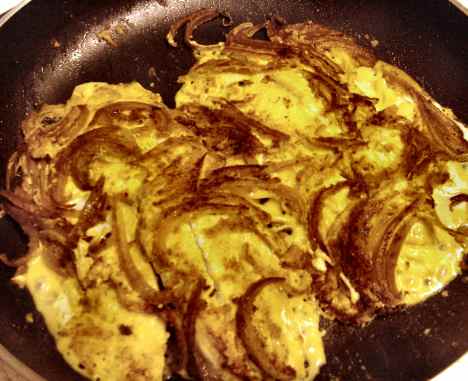 tilapia pan-fried with tehina, hummus, onions and curry spices