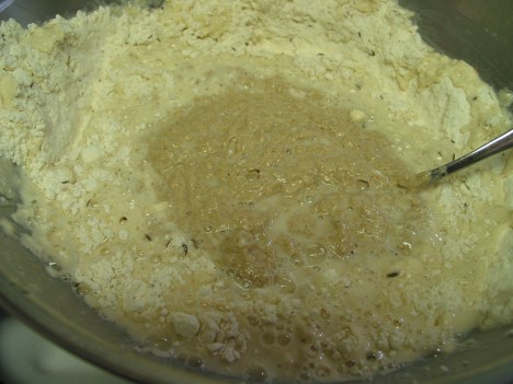 Mixing the rye starter into a bowl with wheat flour and water