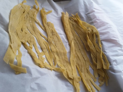 fresh pasta drying on parchment paper 