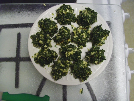 spinach matzah balls on a microwaveable plate, ready to cook